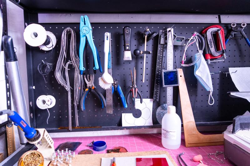 Collection of craftworkers tools on a peg board